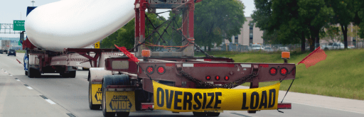 Truck transporting wide load oversized cargo