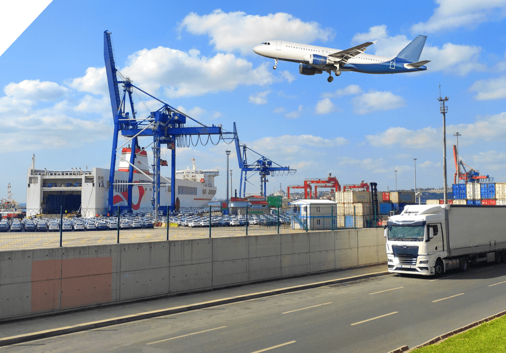 A commercial freight truck travels along a port road as a cargo plane flies overhead, with shipping containers, port cranes, and a large cargo vessel.